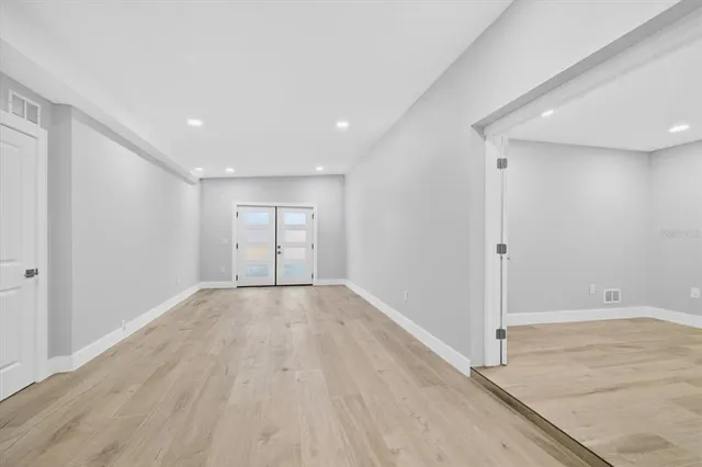 wooden floor in an empty room with a window