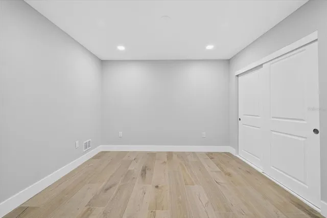 a view of room with wooden floor