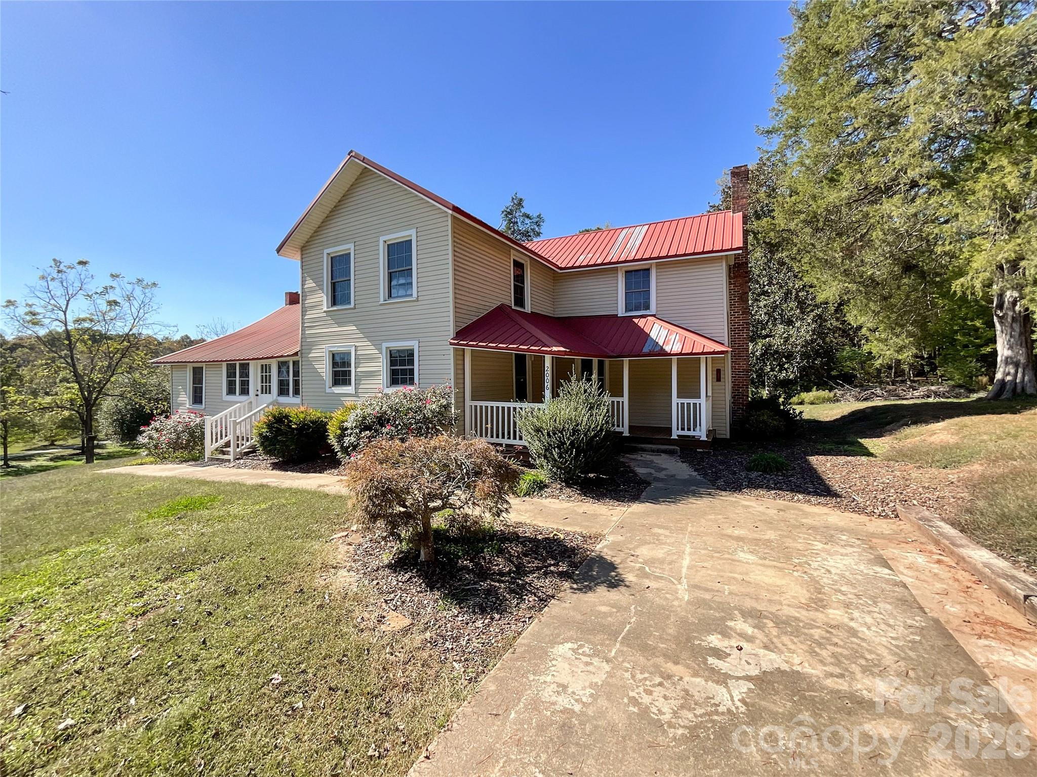 a front view of a house with a yard covered with snow