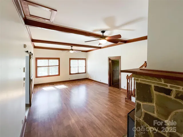 a view of an entryway with wooden floor and staircase