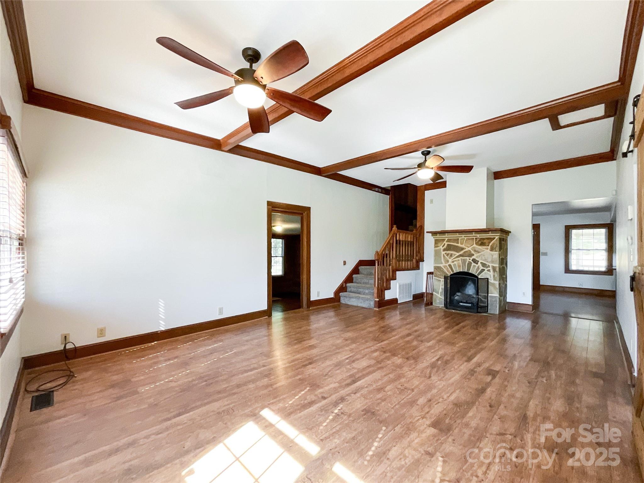 2006 Okeewemee Road Star, NC 27356 - Photo 19 of 48 a view of a livingroom with fireplace a ceiling fan and wooden floor