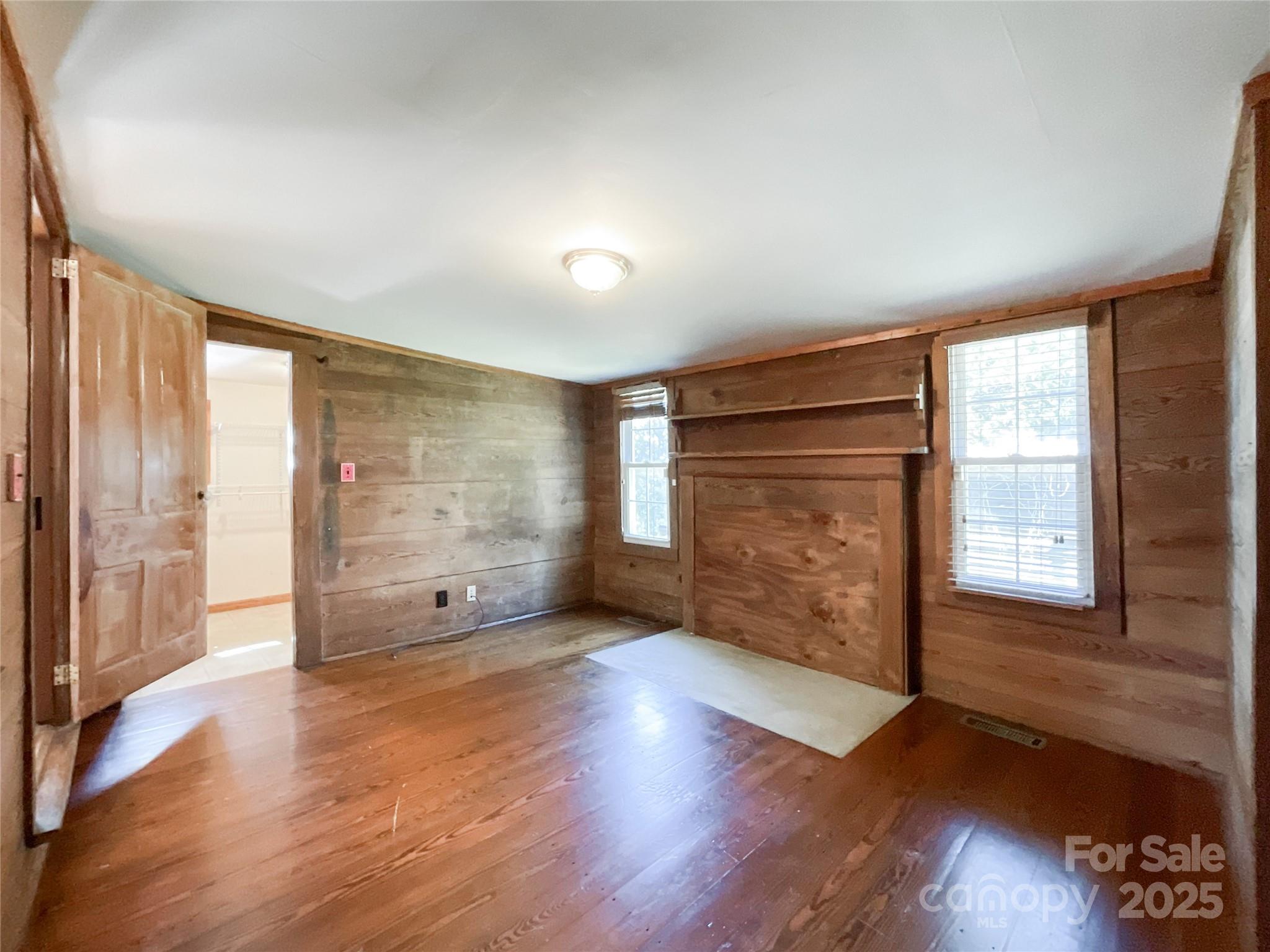 2006 Okeewemee Road Star, NC 27356 - Photo 25 of 48 an empty room with wooden floor and windows with curtains