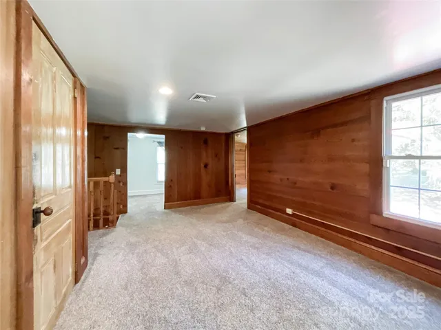 an empty room with windows and closet