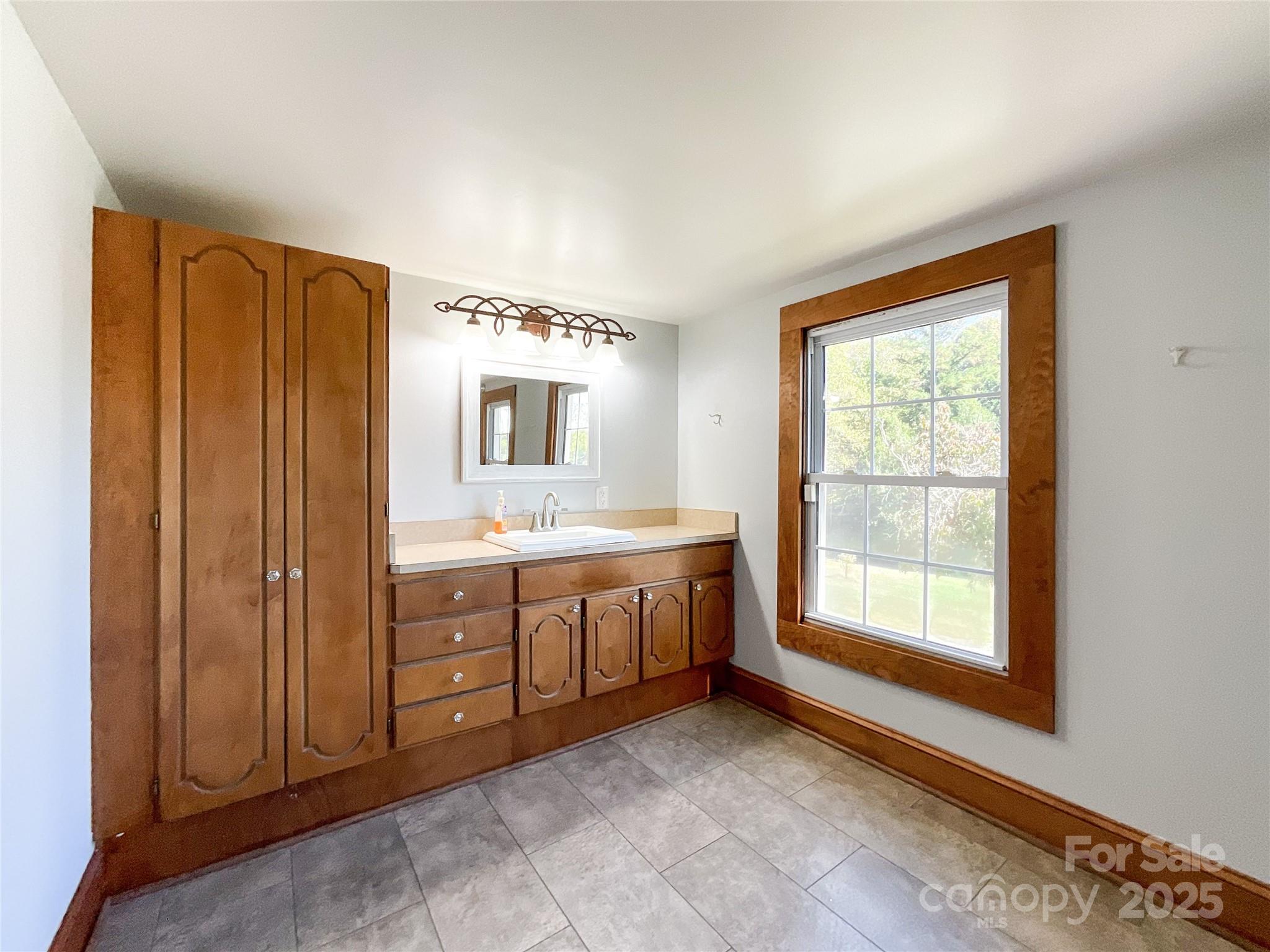 2006 Okeewemee Road Star, NC 27356 - Photo 32 of 48 a spacious bathroom with a double vanity sink a mirror and a bathtub