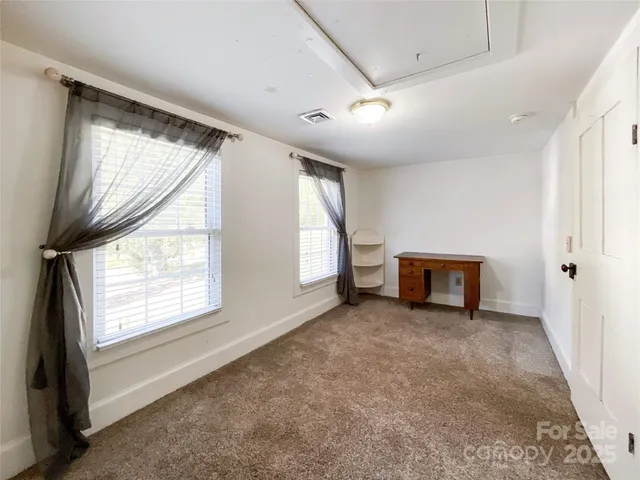 a white house that has a tree in front of it