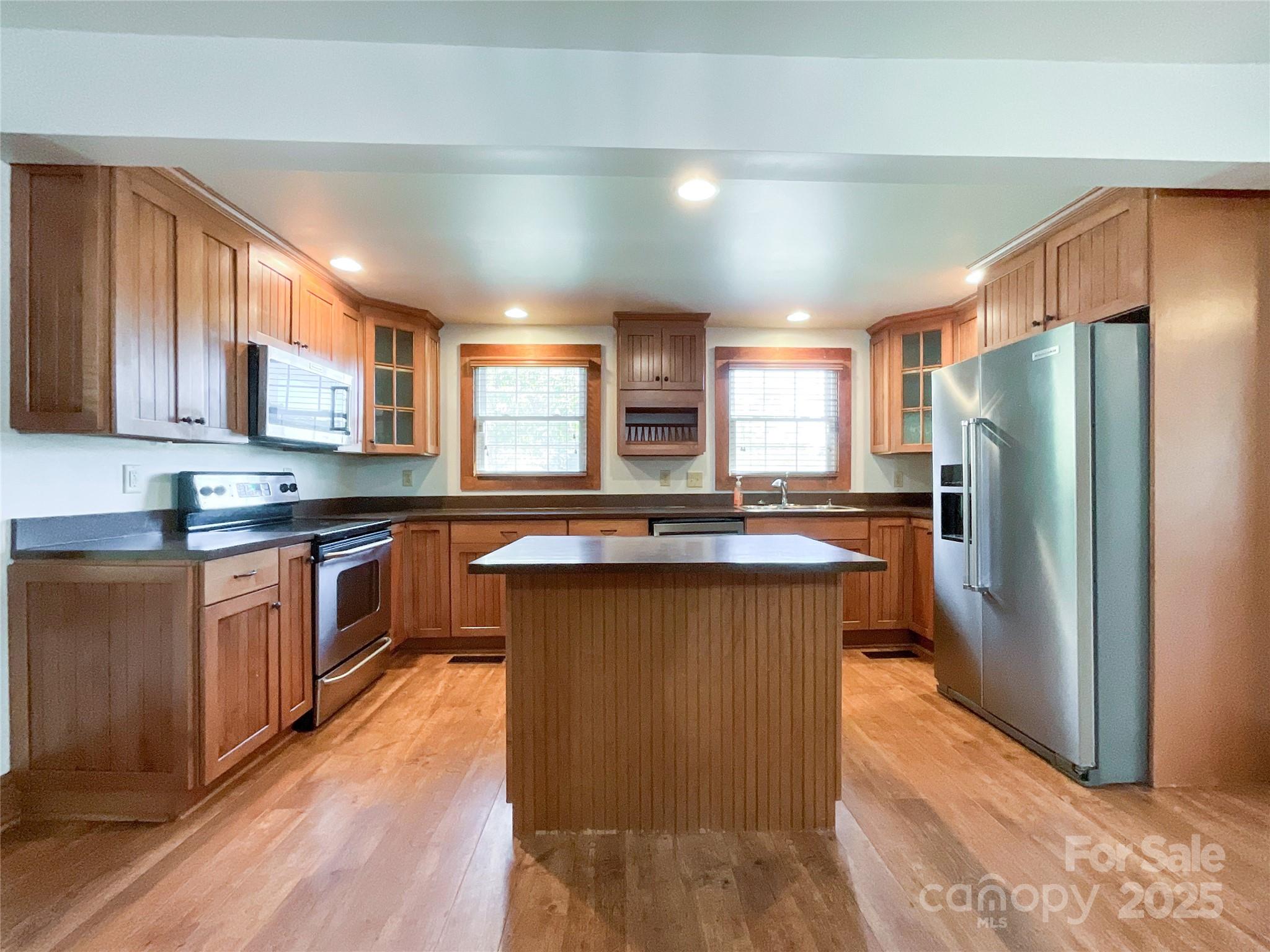 2006 Okeewemee Road Star, NC 27356 - Photo 7 of 48 a kitchen with stainless steel appliances granite countertop a refrigerator a sink dishwasher a stove with wooden cabinets and floor