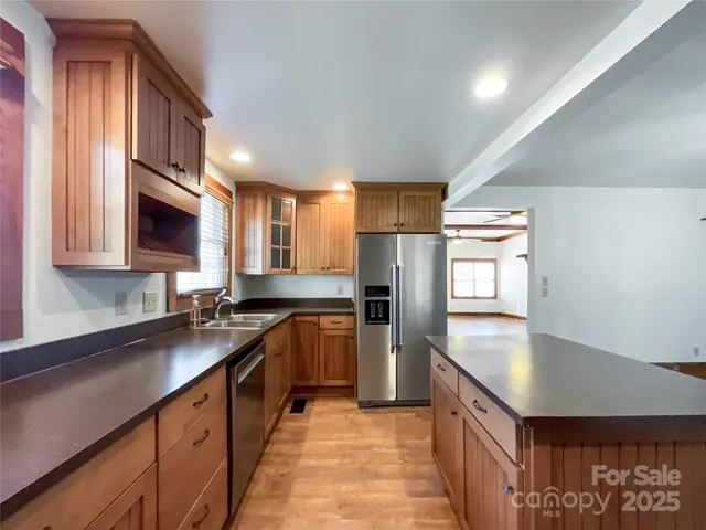 a kitchen with stainless steel appliances granite countertop a stove and a sink