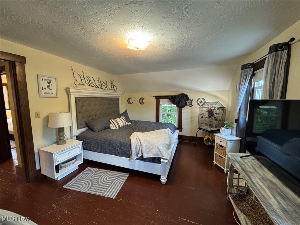 5322 Lockwood Road Madison, OH 44057 - Photo 18 of 30 Bedroom featuring wood finished floors and textured ceiling