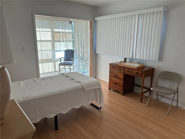 a bedroom with a bed and a chair