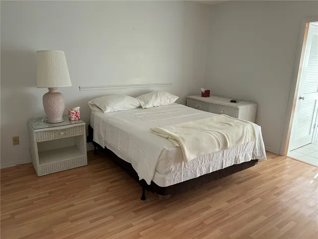 a bedroom with a bed and a lamp