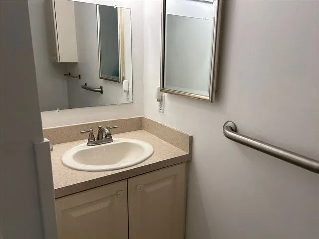 a bathroom with a sink and a mirror