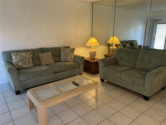 a living room with couches and painted table