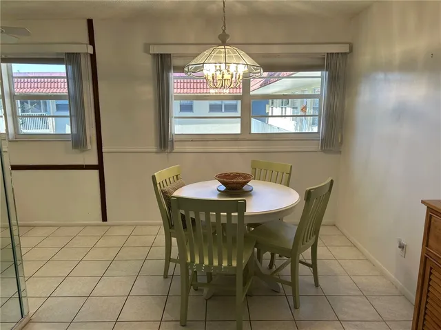 a view of a dining room with furniture and window