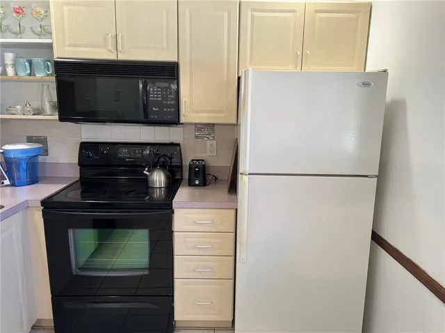 a kitchen with appliances and cabinets