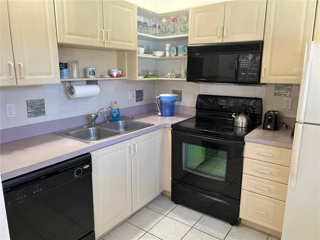 a kitchen with stainless steel appliances granite countertop a stove microwave and sink