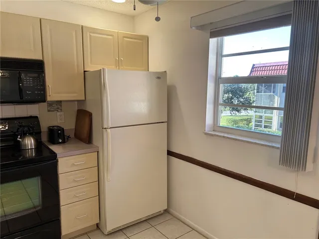 a kitchen with a refrigerator and a stove