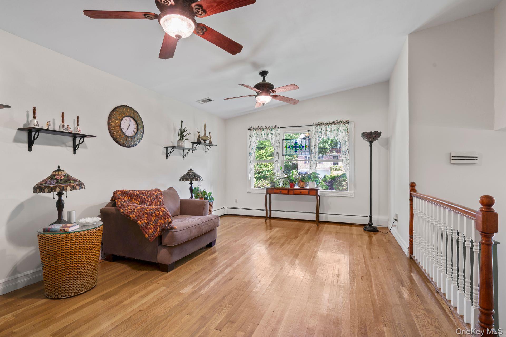 6 Emil Court Huntington, NY 11743 - Photo 13 of 25 a living room with furniture and a chandelier