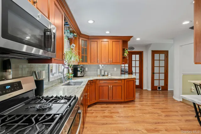 a kitchen with stainless steel appliances granite countertop a stove and a sink