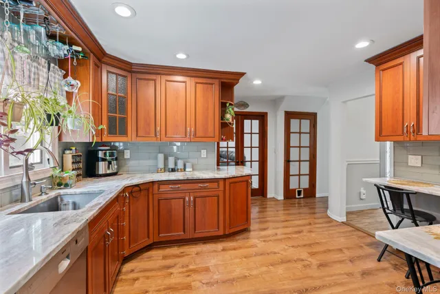 a large kitchen with stainless steel appliances granite countertop a sink and cabinets