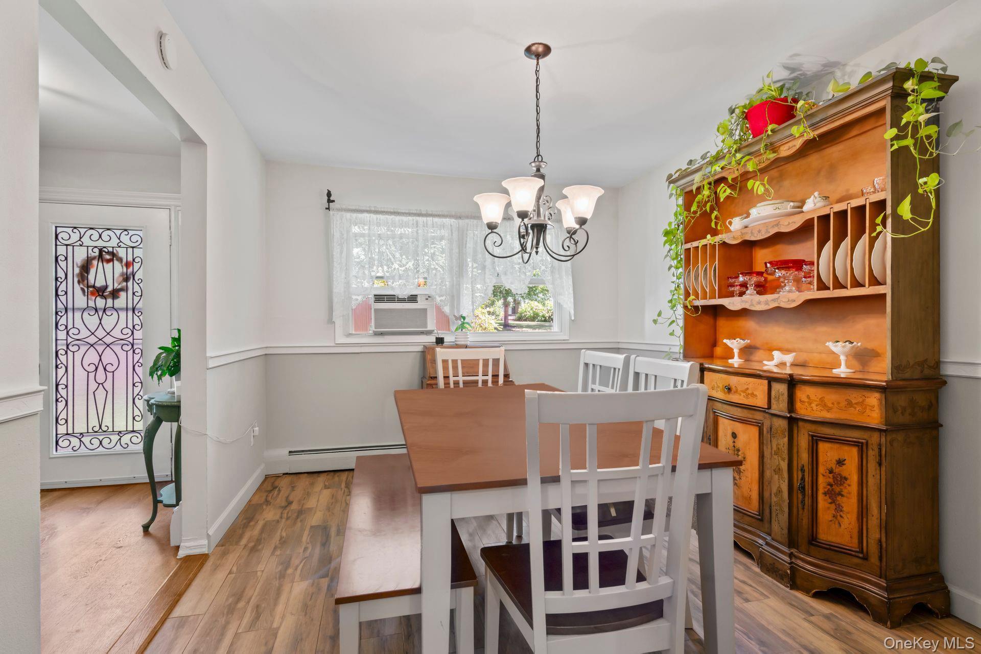 6 Emil Court Huntington, NY 11743 - Photo 6 of 25 a view of a dining room with furniture wooden floor and chandelier