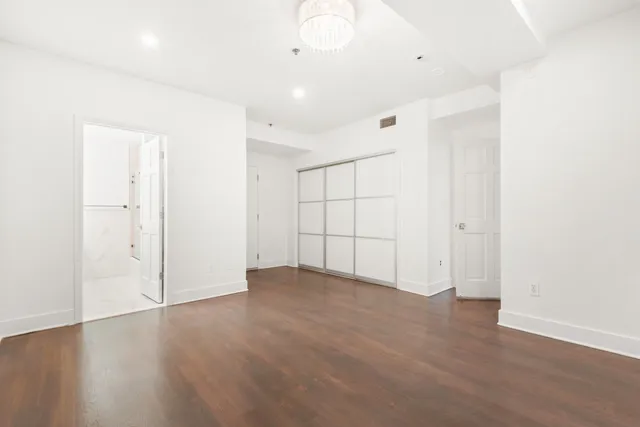 an empty room with wooden floor