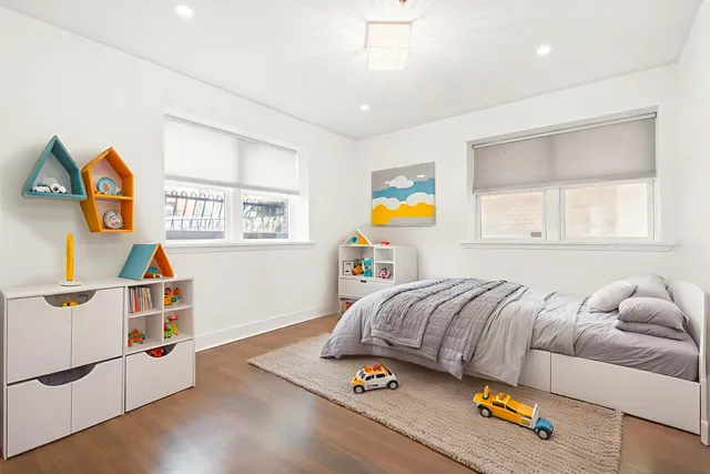 a bedroom with furniture and a wooden floor
