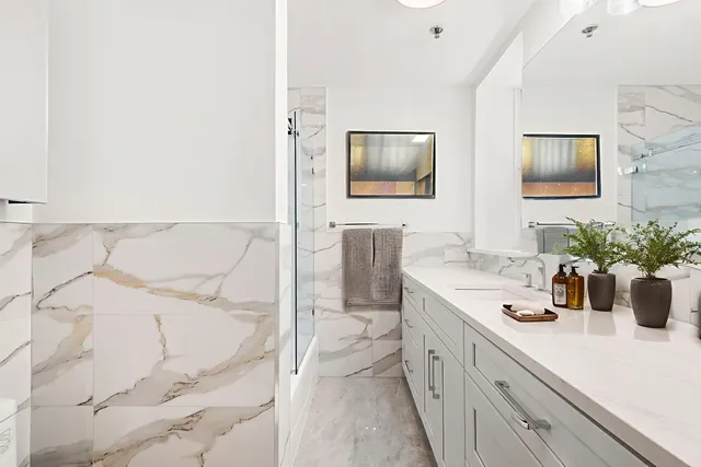 a spacious bathroom with a double vanity sink and a mirror