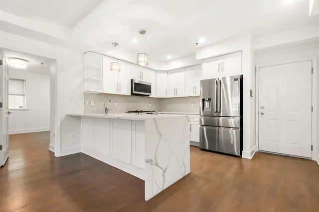 a kitchen with stainless steel appliances a refrigerator stove microwave and sink