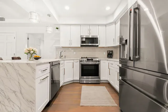 a kitchen with a sink appliances and cabinets