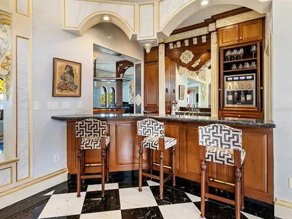 a view of a chairs and table in patio with a barbeque