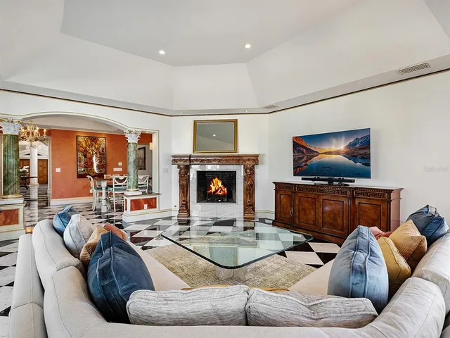 a bathroom with a granite countertop bathtub next to a window and a shower