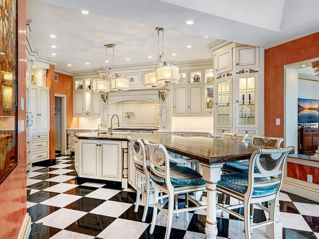 a living room with furniture and floor to ceiling windows