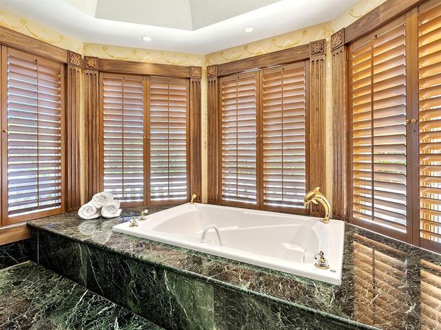 a view of a dining room with furniture large windows and wooden floor