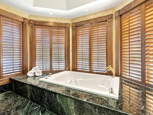 a view of a dining room with furniture large windows and wooden floor