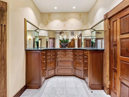 a front view of a house with garden and trees