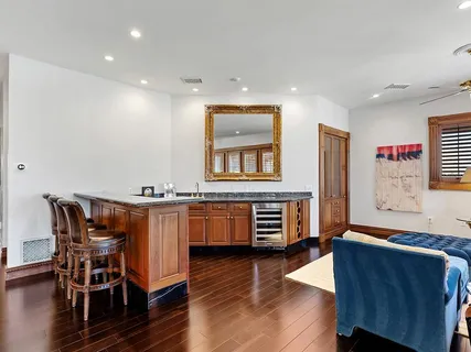 a view of swimming pool with outdoor seating and a garden