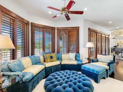 a front view of a house with swimming pool having outdoor seating