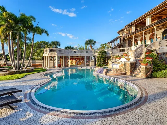 a aerial view of a house with a garden and lake view