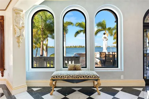 a living room with couches a table and chairs with wooden floor