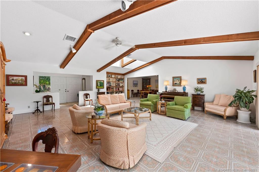 114 North Beach Road Hobe Sound, FL 33455 - Photo 17 of 37 a living room with furniture and a flat screen tv