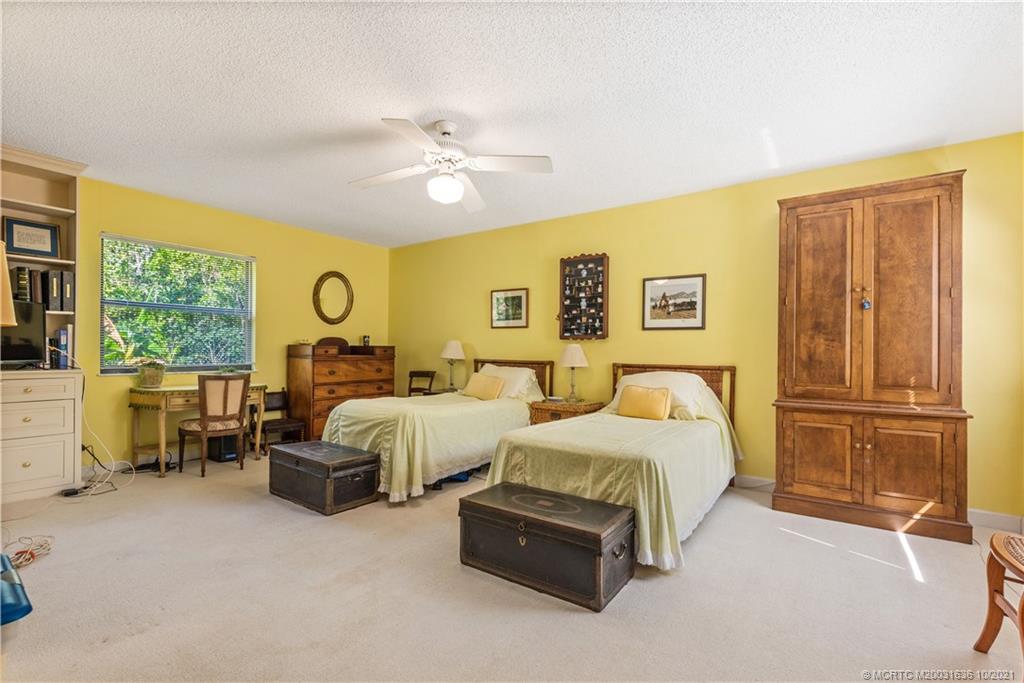 114 North Beach Road Hobe Sound, FL 33455 - Photo 23 of 37 a spacious bedroom with a bed and a window