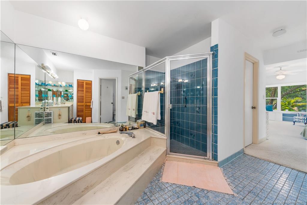 114 North Beach Road Hobe Sound, FL 33455 - Photo 28 of 37 a spacious bathroom with a bathtub and a shower
