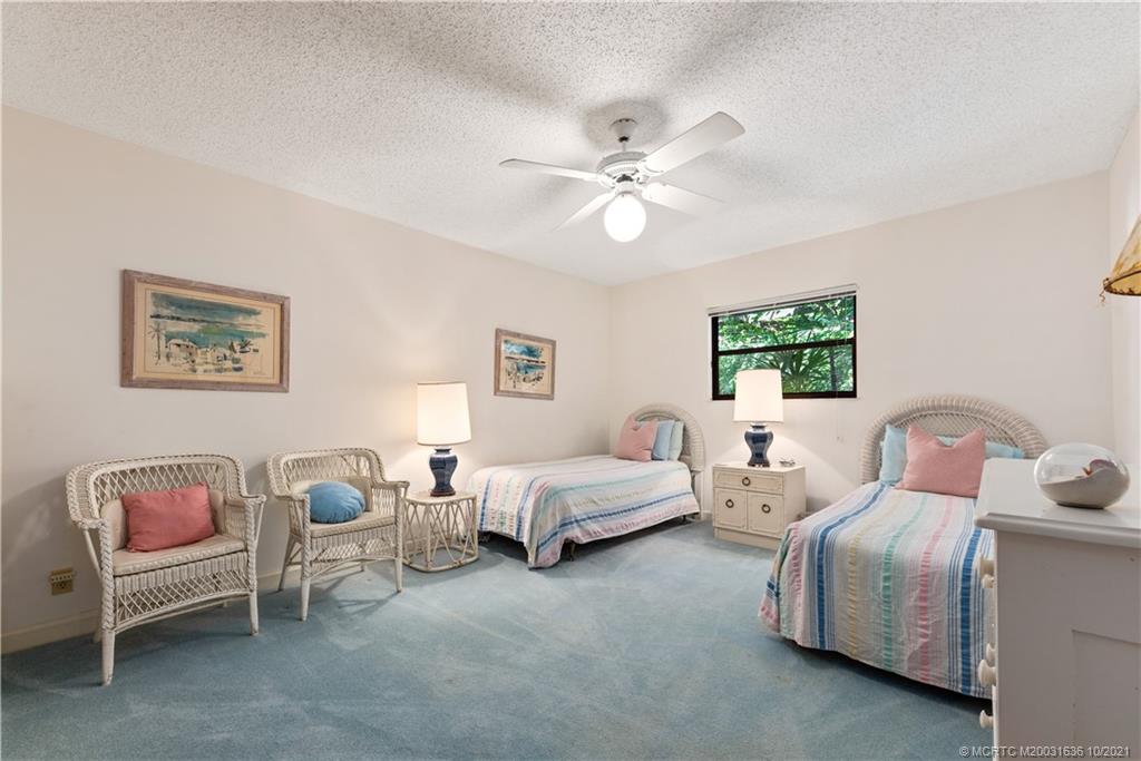114 North Beach Road Hobe Sound, FL 33455 - Photo 31 of 37 a bed room with two bed and a chandelier