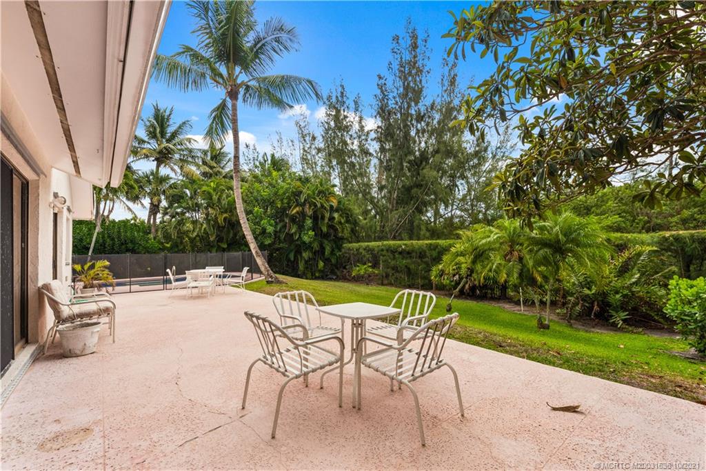 114 North Beach Road Hobe Sound, FL 33455 - Photo 35 of 37 a view of a backyard with a patio and swimming pool