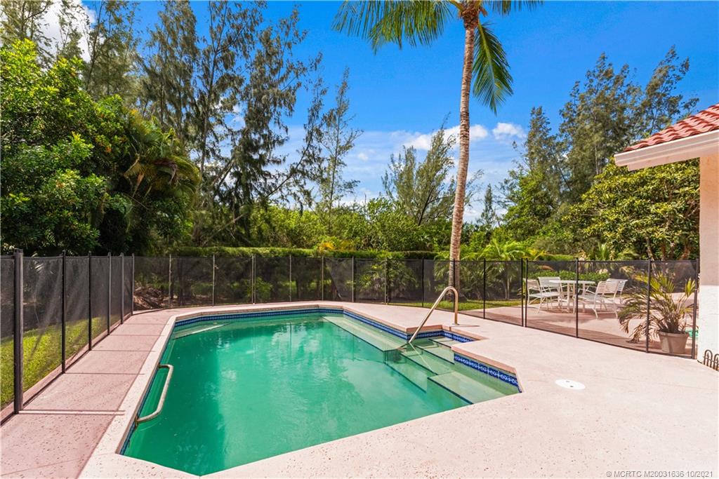 114 North Beach Road Hobe Sound, FL 33455 - Photo 36 of 37 a swimming pool with wooden fence