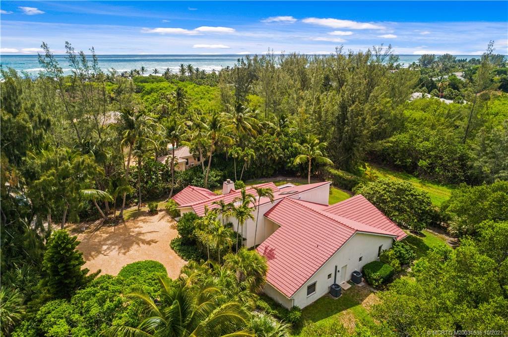 114 North Beach Road Hobe Sound, FL 33455 - Photo 8 of 37 a view of a swimming pool with a yard