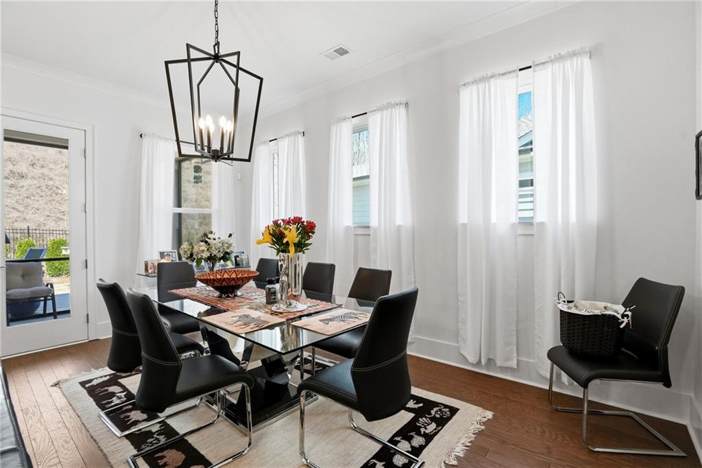 6742 Welcome Road Flowery Branch, GA 30542 - Photo 13 of 48 a view of a dining room with furniture window and wooden floor
