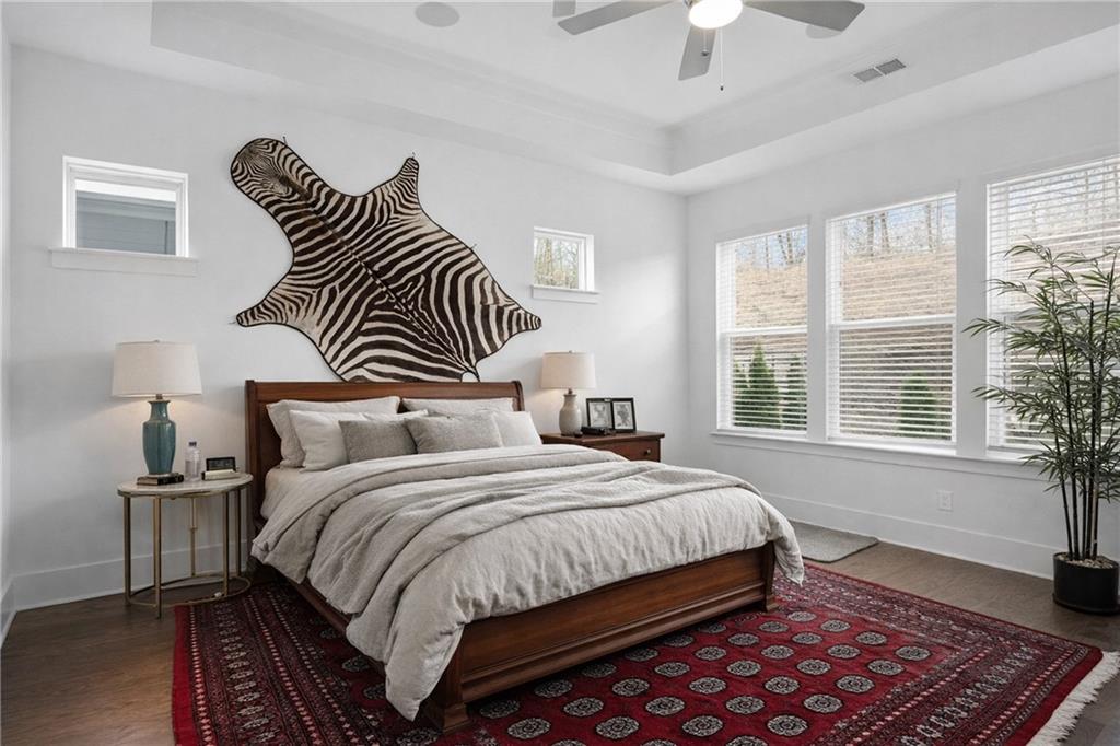 6742 Welcome Road Flowery Branch, GA 30542 - Photo 14 of 48 a bedroom with a bed and a chandelier