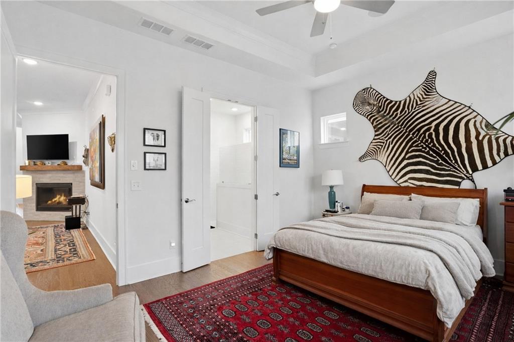 6742 Welcome Road Flowery Branch, GA 30542 - Photo 15 of 48 a bedroom with a bed and a chandelier