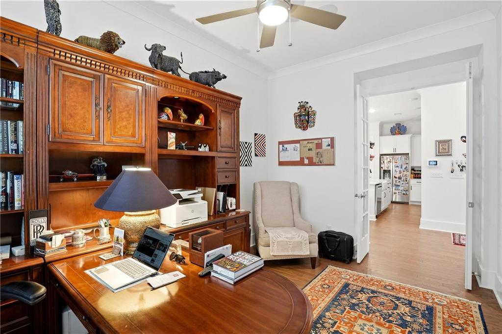 6742 Welcome Road Flowery Branch, GA 30542 - Photo 24 of 48 a living room with furniture a rug and a chandelier